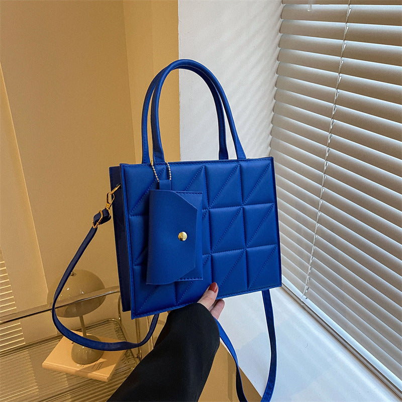 Simple elegant portable shoulder small square bag in blue PU material with sewing thread details.